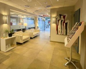 a lobby with couches and a painting on a wall at SM Hotel Sant Antoni in Barcelona