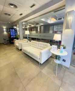 a lobby with white couches and a table with lamps at SM Hotel Sant Antoni in Barcelona