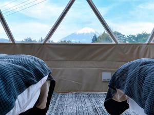 two beds in a tent with a view of a mountain at dots by Dot Glamping Suite 001 in Fujikawaguchiko