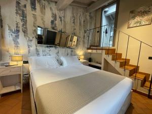 a bedroom with a large bed and a staircase at Dimora Carducci in Pietrasanta