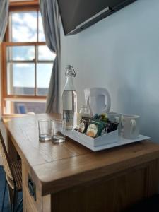 a table with a bottle and glasses on it at Fort Charlotte Guest House in Lerwick