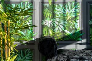 a window with a bunch of plants in a room at Cocooning Romance in Leicester in Leicester