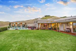 an image of a house with a yard at Mountainview Villa Luxury Lodge & Glamping in Blenheim