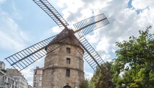 a large stone windmill in the middle of a city at Bel appartement F3 46m2 à 5' de Paris in Ivry-sur-Seine
