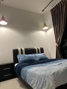 a bedroom with a bed with two lights on it at Educity Legoland Eco Botanic Homestay in Johor Bahru +23 photos