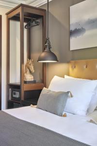 a bedroom with a bed with a horse statue next to it at Hotel Cortes Rambla in Barcelona
