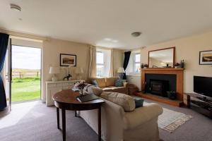 a living room with a couch and a table at Blackhill Farm Cottage in Perth