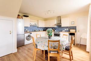 a kitchen with a table and chairs in a kitchen at Blackhill Farm Cottage in Perth