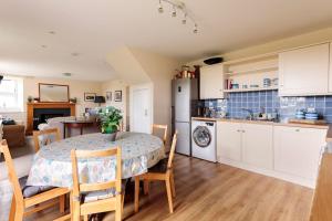 a kitchen and a dining room with a table and chairs at Blackhill Farm Cottage in Perth