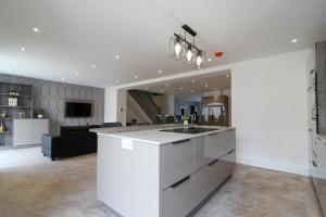 a kitchen and living room with a white counter top at Northumberland Luxury Stays - The Gavel in West Chevington