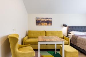 a living room with a couch and a table at Amber Drop apartments in Palanga
