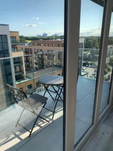 a chair on a balcony with a view of a city at Ackroyd House, Edinburgh Way in Harlow