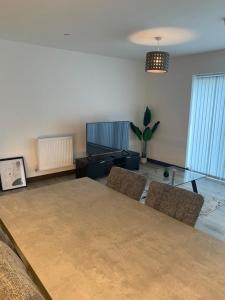 a living room with a glass table and chairs at Ackroyd House, Edinburgh Way in Harlow