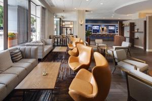 a lobby with couches and chairs and a bar at Winston-Salem Marriott in Winston-Salem