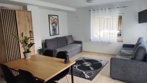 a living room with a table and a couch at Pokoje Gościnne in Lębork