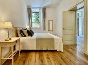 a bedroom with a bed and a table and a window at Palazzo Pitagora in Taranto