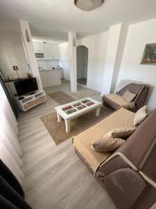 a living room with a couch and a table at Apartment Panorama Mostar in Mostar