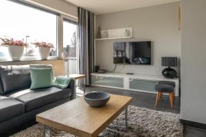 a living room with a couch and a tv at Postwiese in Winterberg