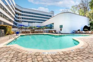 uma piscina em frente a um edifício em DoubleTree by Hilton South Charlotte Tyvola em Charlotte