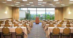 a conference room with tables and chairs in it at DoubleTree by Hilton Bloomington Minneapolis South in Bloomington