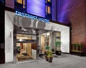 a hotel entrance with a sign that reads district hotel at Distrikt Hotel New York City, Tapestry Collection by Hilton in New York
