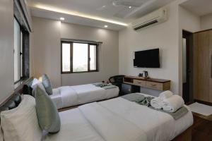 Postel nebo postele na pokoji v ubytování Hotel Ozone Inn Colaba