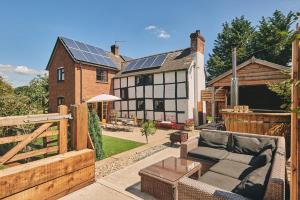a backyard with a house with solar panels on it at Powk Meadow Farmhouse in Leominster