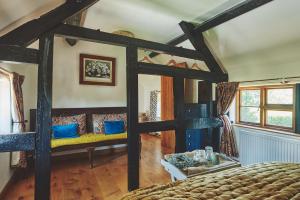 a bedroom with a large bed with blue pillows at Powk Meadow Farmhouse in Leominster