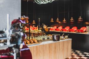 a bakery with a buffet of pastries on display at Tremonti Hotel Karpacz in Karpacz