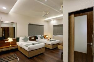 Postel nebo postele na pokoji v ubytování Hotel Ozone Inn Colaba