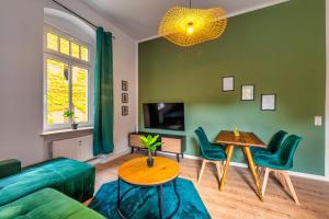 een woonkamer met een bank en een tafel en stoelen bij unique Malterstraße feel-good-home - Dresden in Dresden