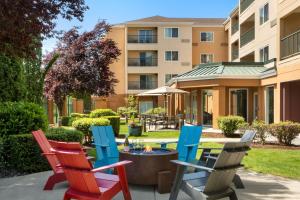 a group of chairs sitting on a patio in front of a building at Courtyard Seattle North / Lynnwood Everett in Lynnwood