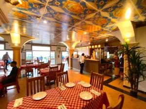a dining room with a table and a floral ceiling at Little Italy Hotel in Nuku‘alofa