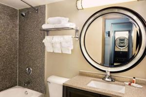 a bathroom with a sink and a mirror at Express Inn and Suites in Little Rock