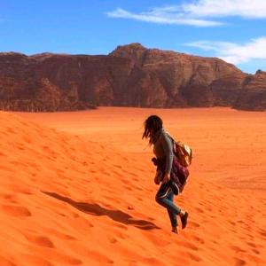 a person running through the desert at Bedouin bunch camp in Wadi Rum