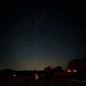 a couple sitting on a bench under a starry sky at Bedouin bunch camp in Wadi Rum