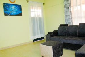 a living room with a couch and a chair at KAJIADOHOMES in Kajiado