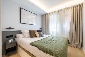 a bedroom with a large bed and a window at Silva 20 in Madrid