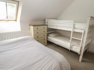 a bedroom with two bunk beds and a window at One Tree House in Dinas