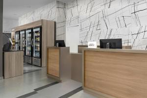 a cashier counter in a store with a wall at Residence Inn by Marriott New York Queens in Queens