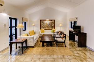 a living room with a couch and a table at Habarana Village by Cinnamon in Sigiriya