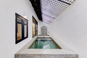 a swimming pool in the middle of a white building at Habarana Village by Cinnamon in Habarana
