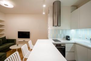 a kitchen with a table and chairs and a couch at Psaradika Apartment Modern Comfort in Corfu Old Town in Corfu