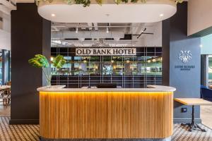 an old bank hotel lobby with a yellow bar at Old Bank Hotel - Lion Roars Hotels & Lodges in Cape Town