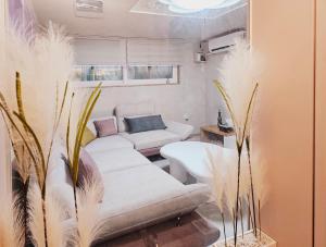 a living room with two white couches and plants at Close to Gangnam, COEX & Luxury Apartment near Lotte world in Seoul