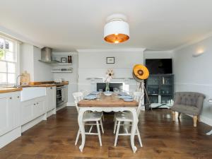 a kitchen with a table and chairs in a room at Pass the Keys Stunning garden flat with parking in Bath