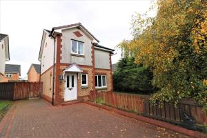 a house with a fence and a brick driveway at Signature - Angus House Glasgow in Glasgow