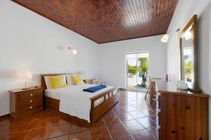 a bedroom with a bed and a desk in it at Villa Oliveira in Aljezur +22 photos