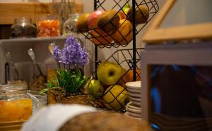 a table with a bowl of fruit and a plant at Hotel Boutique Cerro del Sol Adults only recommended in Granada