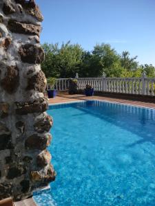 a large swimming pool next to a stone wall at CASA COREA IV in Puntagorda